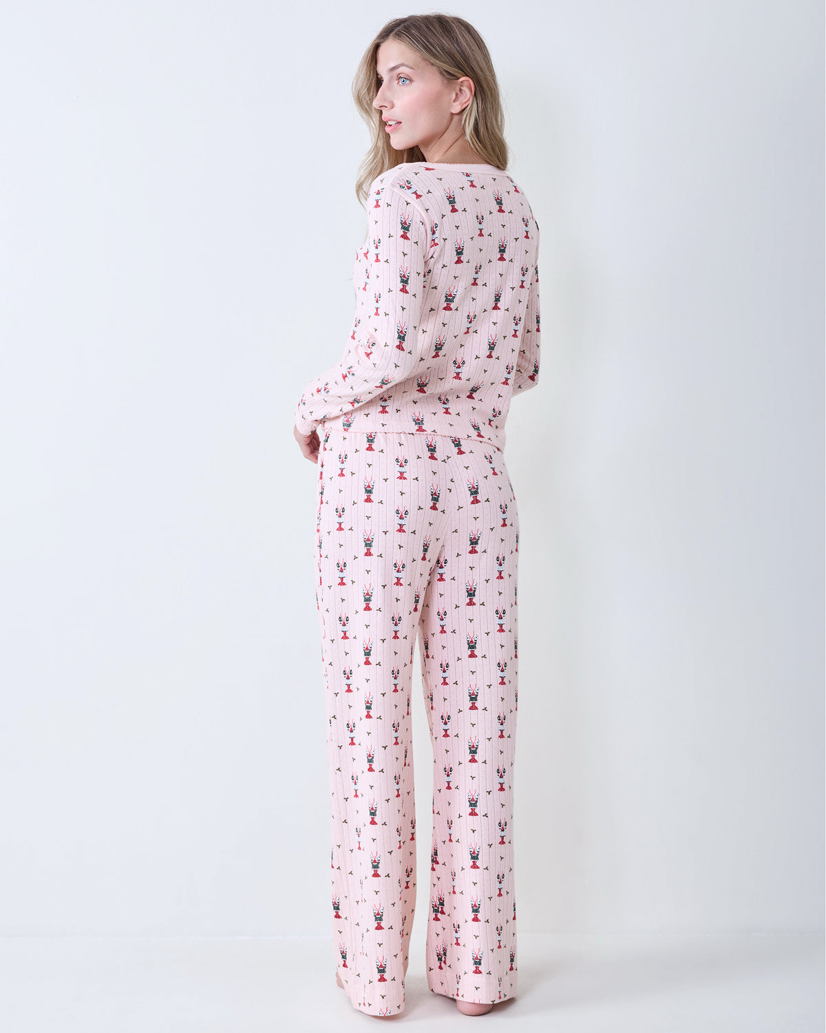 Back view of the Christmas Claws Kaylee pajama set with matching printed long-sleeve top and pants.