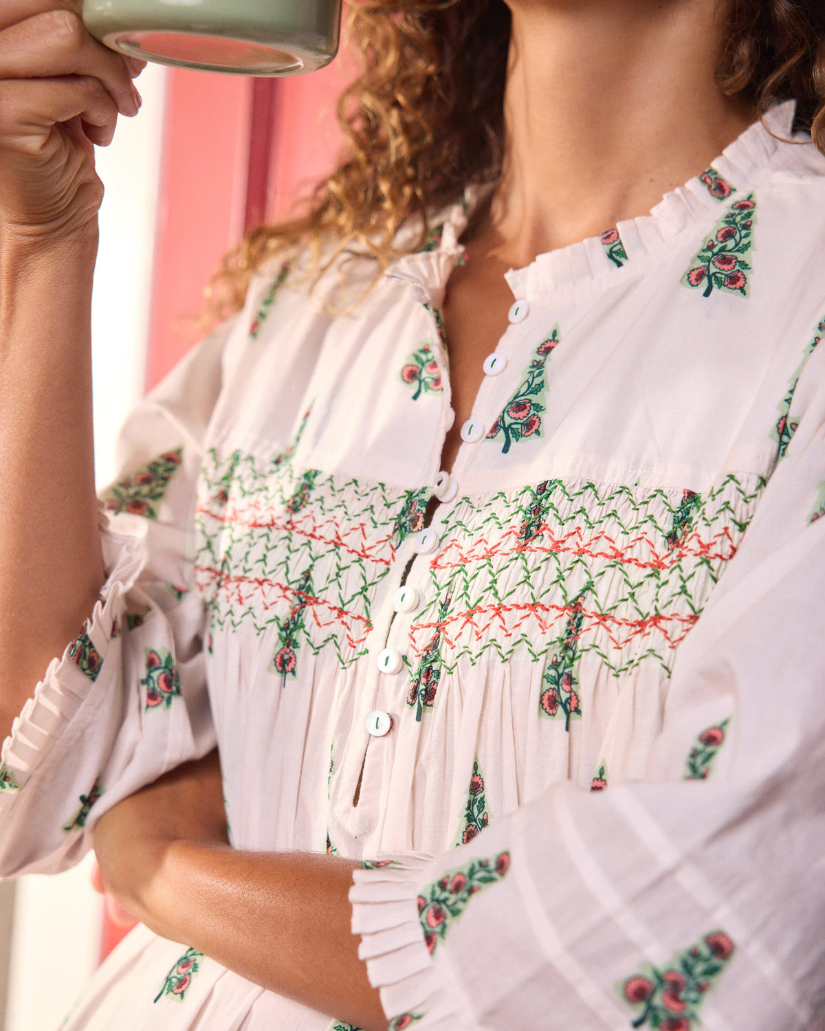 Close-up of the nightgown’s embroidered chest panel, button front, floral print, and ruffled sleeve cuff.