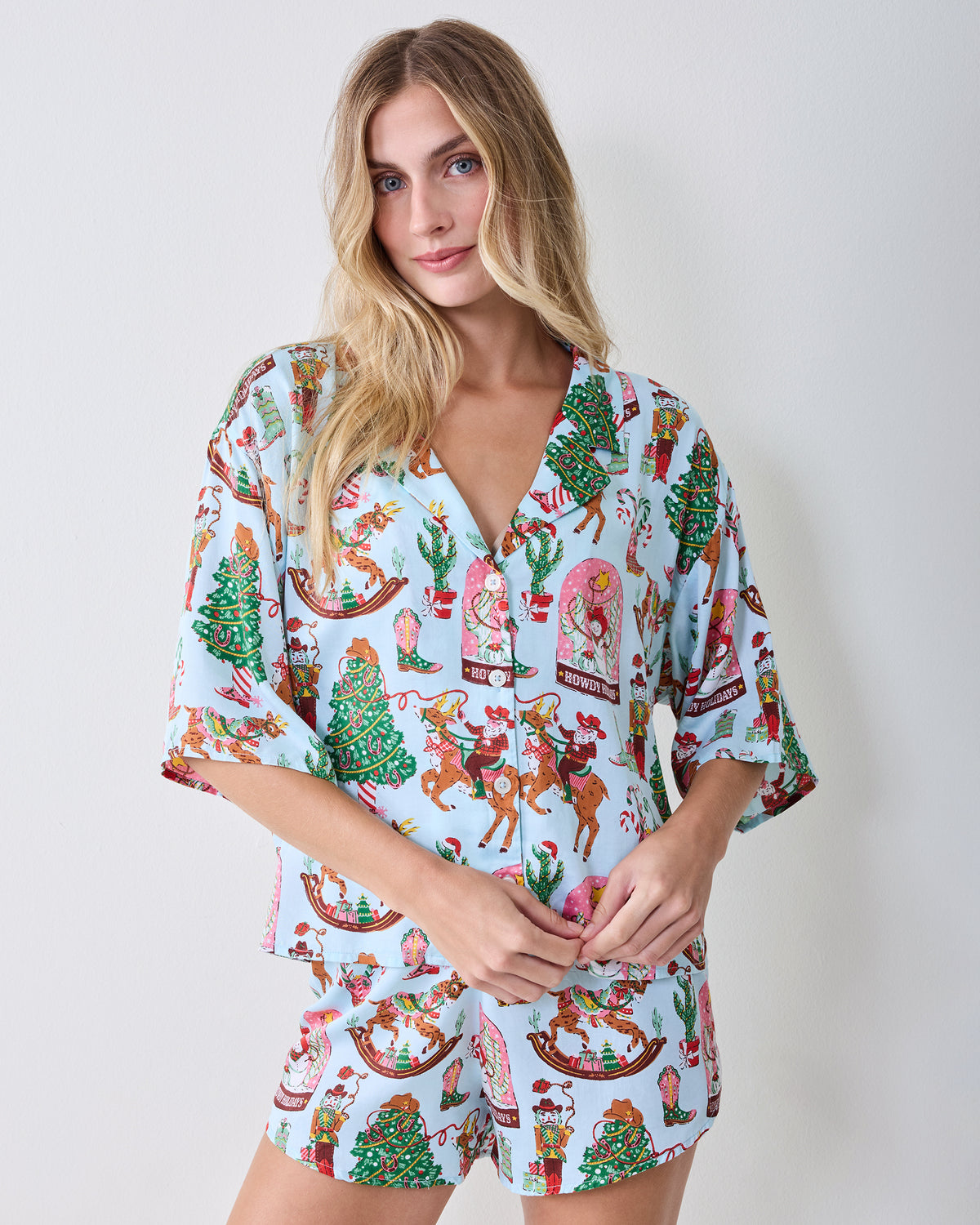 Front view of the short button-down pajama top and matching shorts in the Cowboy Christmas print.