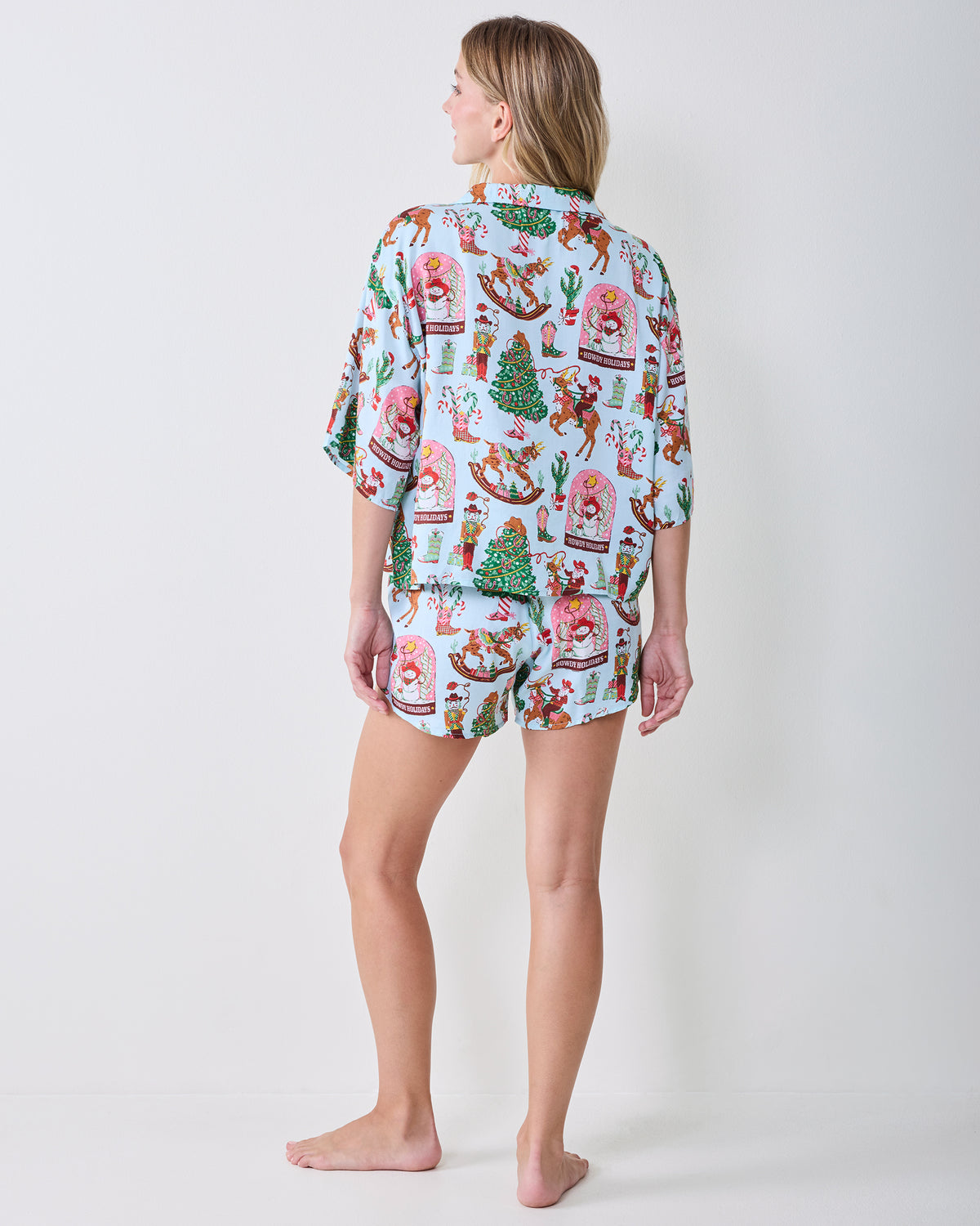 Back view of the matching short-sleeve top and shorts in the Cowboy Christmas print.