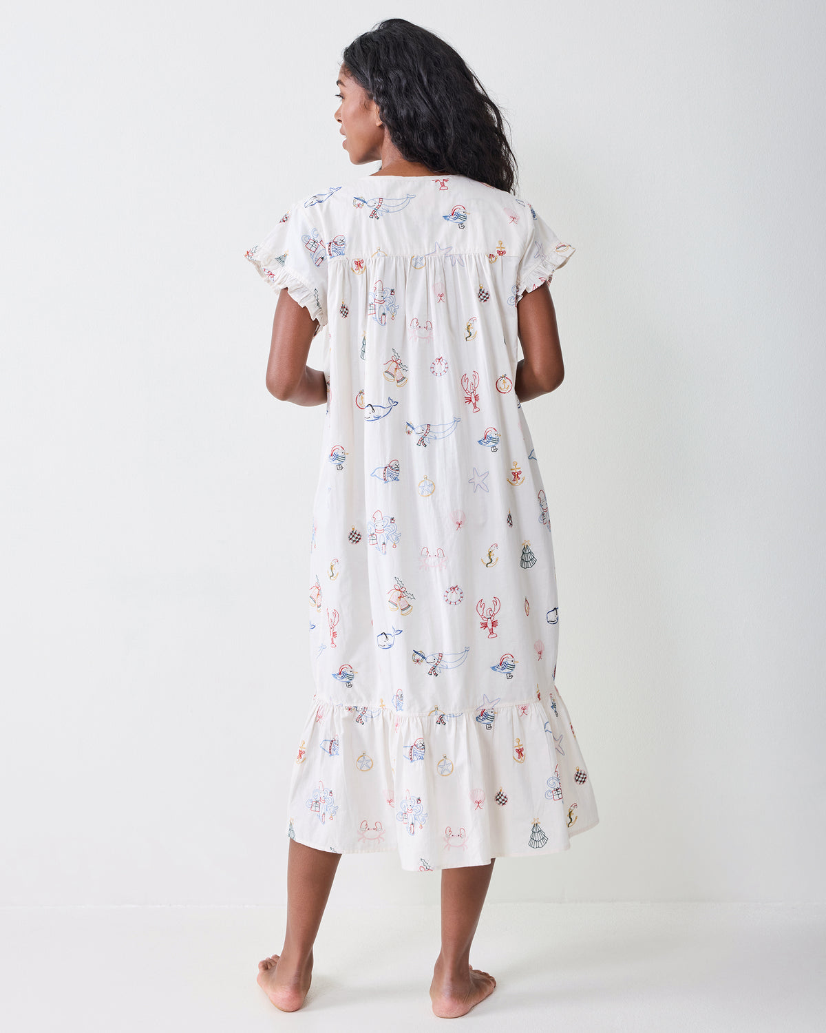 Back view of the embroidered Yule Tides cloud Daylight Nightgown, showing its loose fit, short sleeves, and tiered hem.