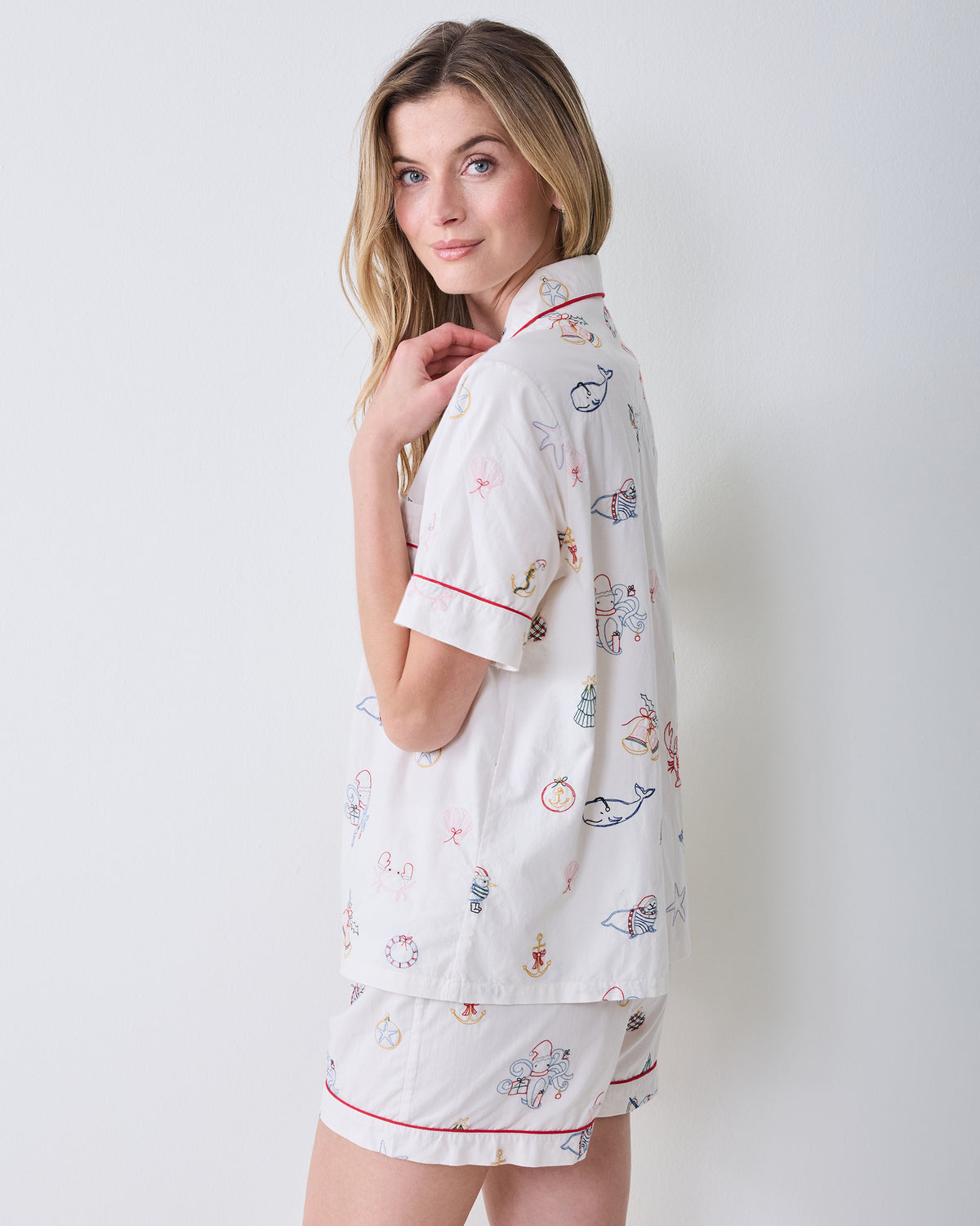 Side view of the embroidered Yule Tides cloud Short PJ Set showing the shirt, sleeve cuff, collar, and matching shorts.