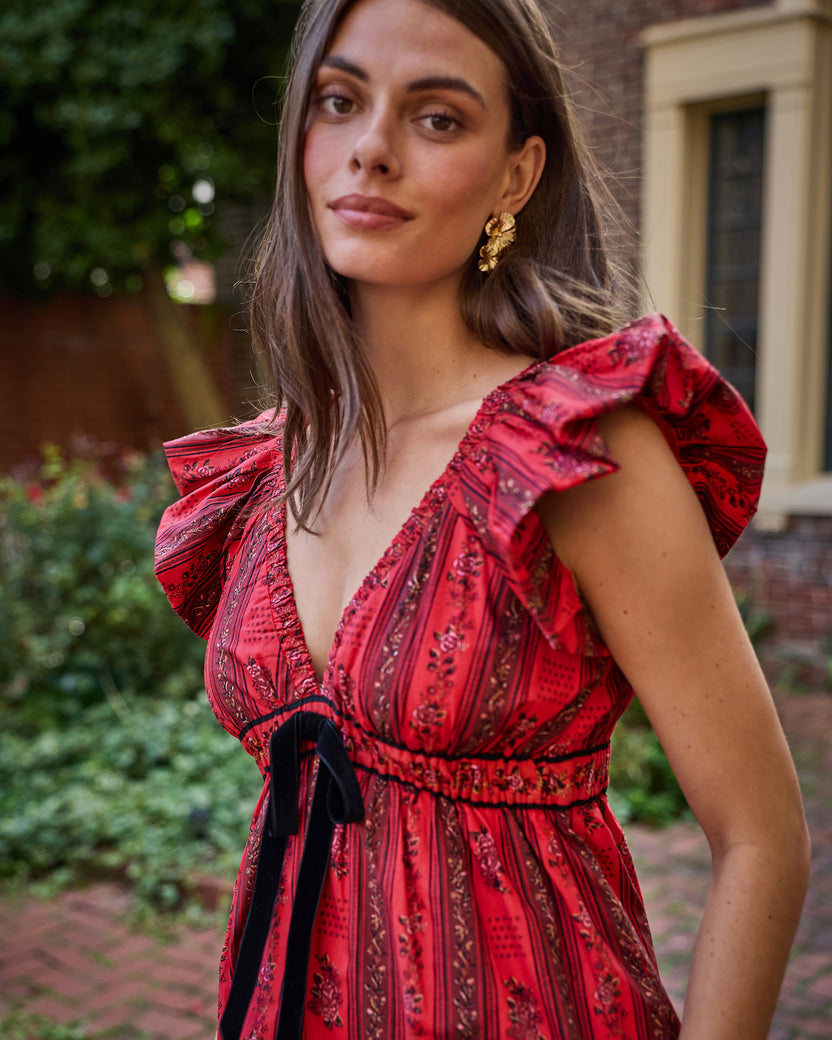 Close view of the Heirloom Red Festive Roses Cecily dress with ruffled sleeves, a V-neckline, and a waist tie.