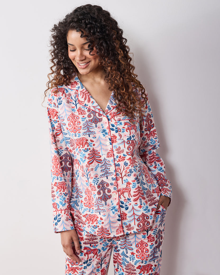 Close front view of the cream Folklore Forest long pajama set showing the collared button-front top, pocket, and matching print.