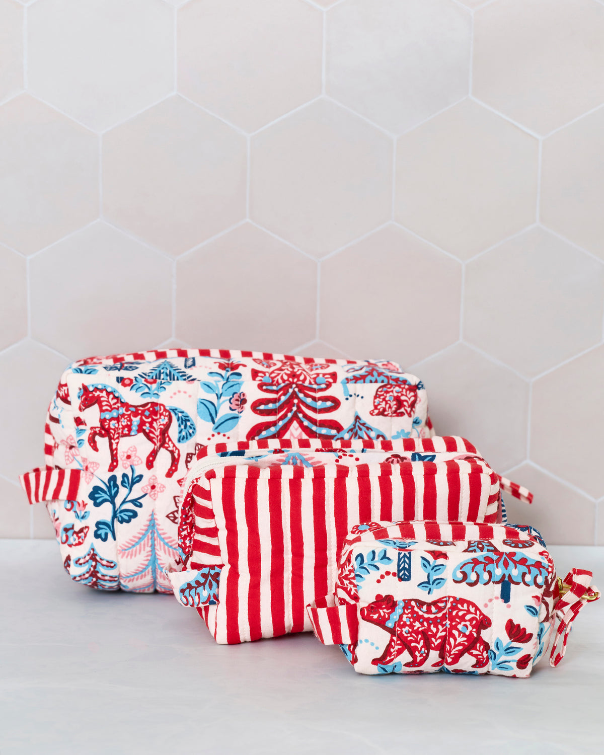 Three Folklore Forest pouches displayed together, with patterned and red-and-white striped designs.