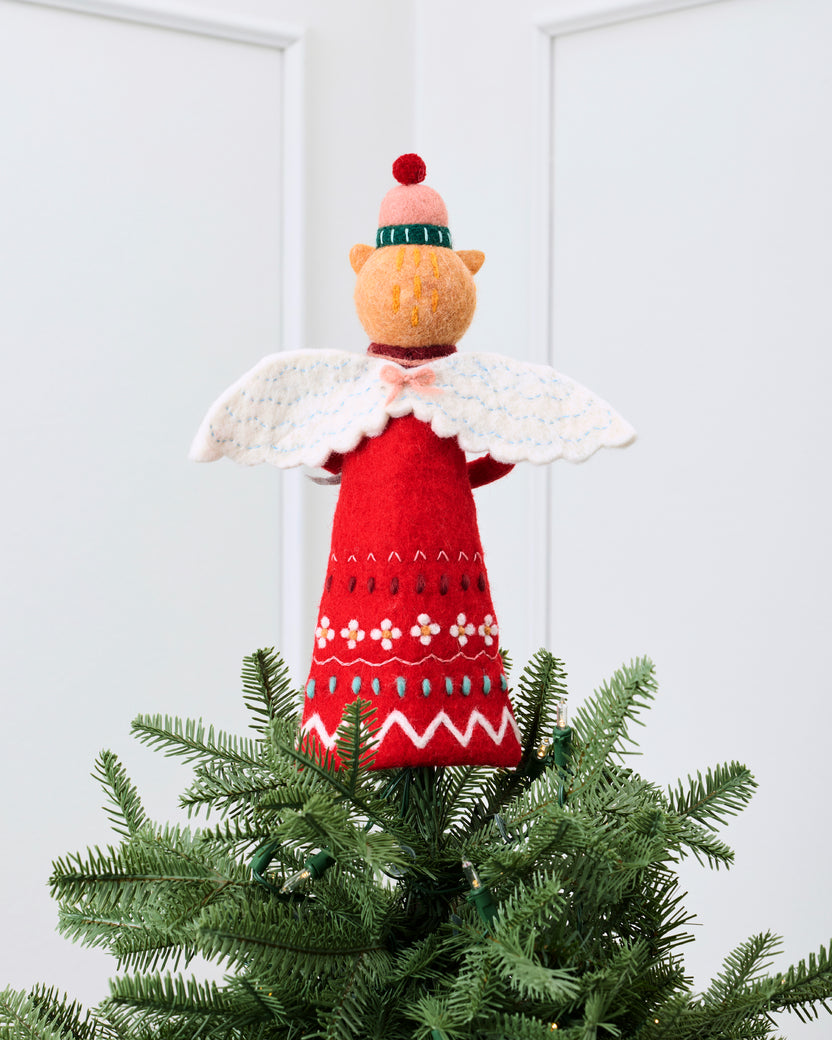 Cat tree topper in a red embroidered outfit with a white cape, displayed on top of a Christmas tree.