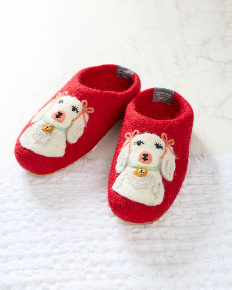 Pair of red slippers with white embroidered dogs wearing green collars and gold bell details.