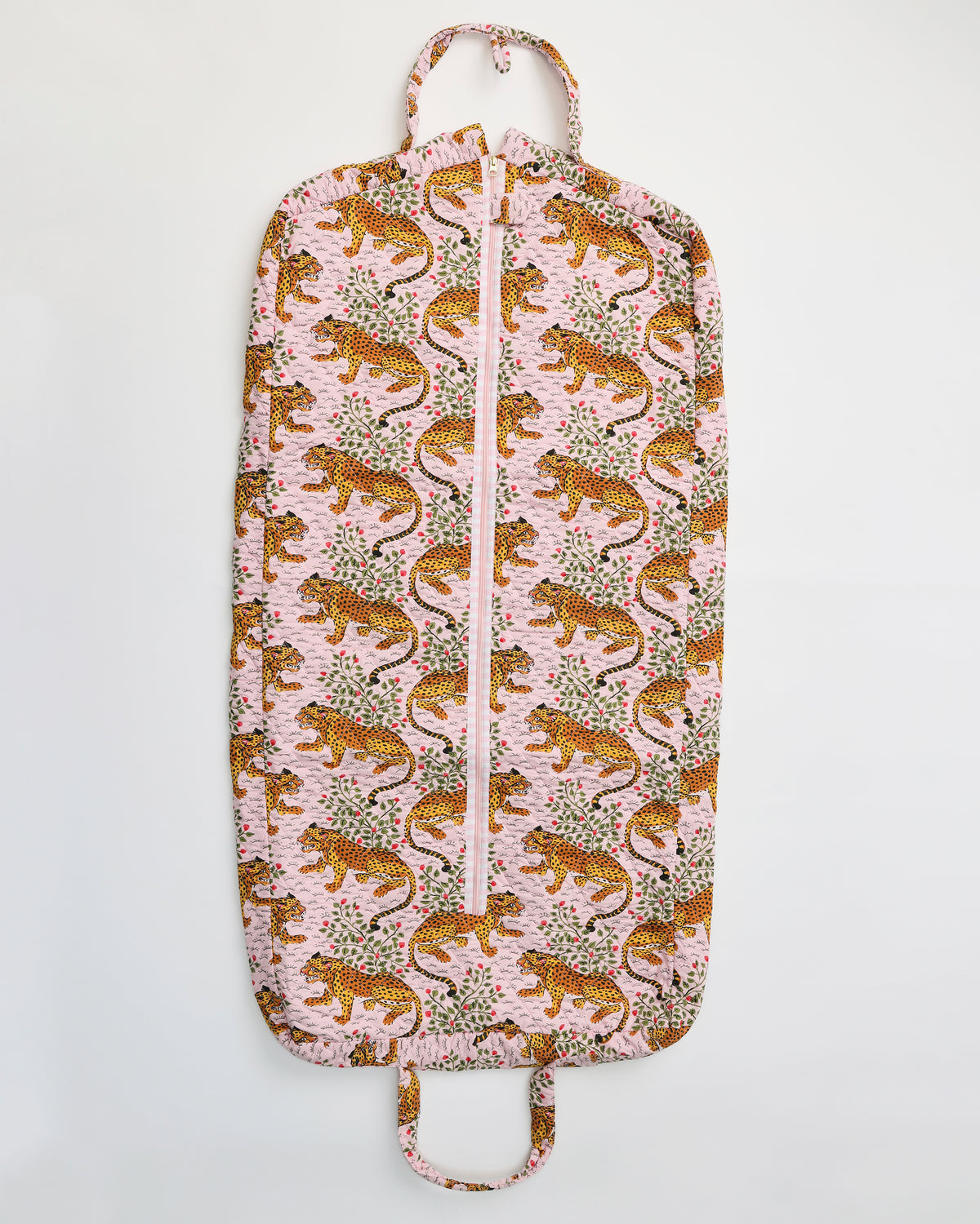 Flat view of the Bagheera blush garment bag with a front zipper, top hanger loop, bottom handle, and leopard-and-botanical print.