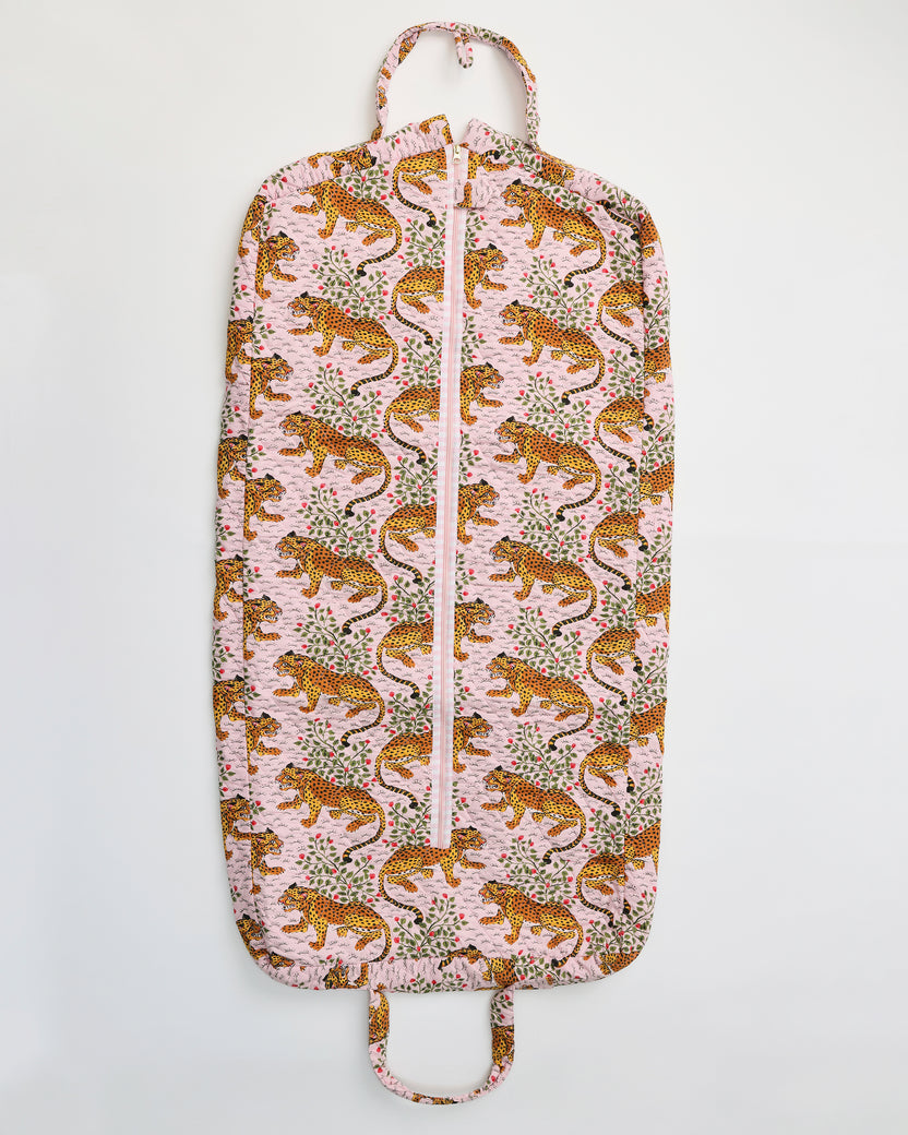 Flat view of the Bagheera blush garment bag with a front zipper, top hanger loop, bottom handle, and leopard-and-botanical print.