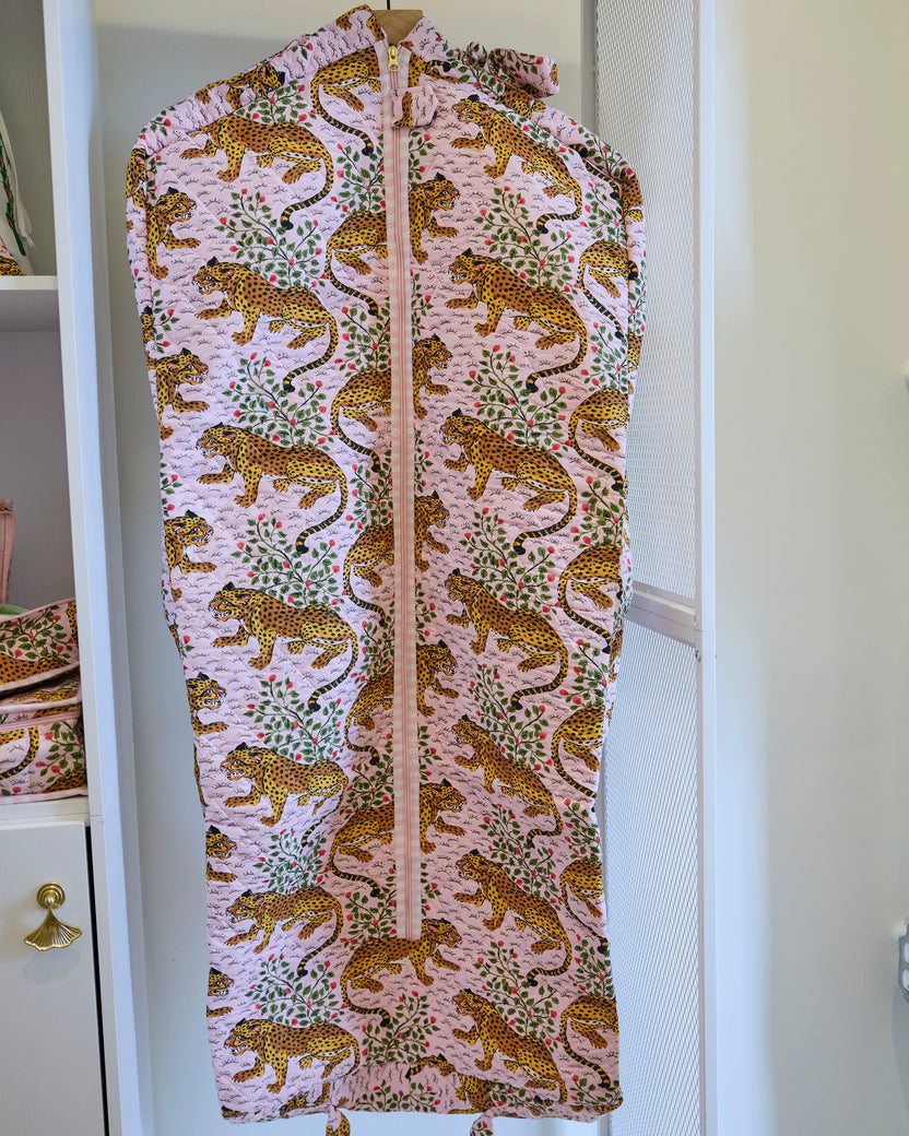 Close front view of the Bagheera blush garment bag with a zipper and leopard-and-botanical print.