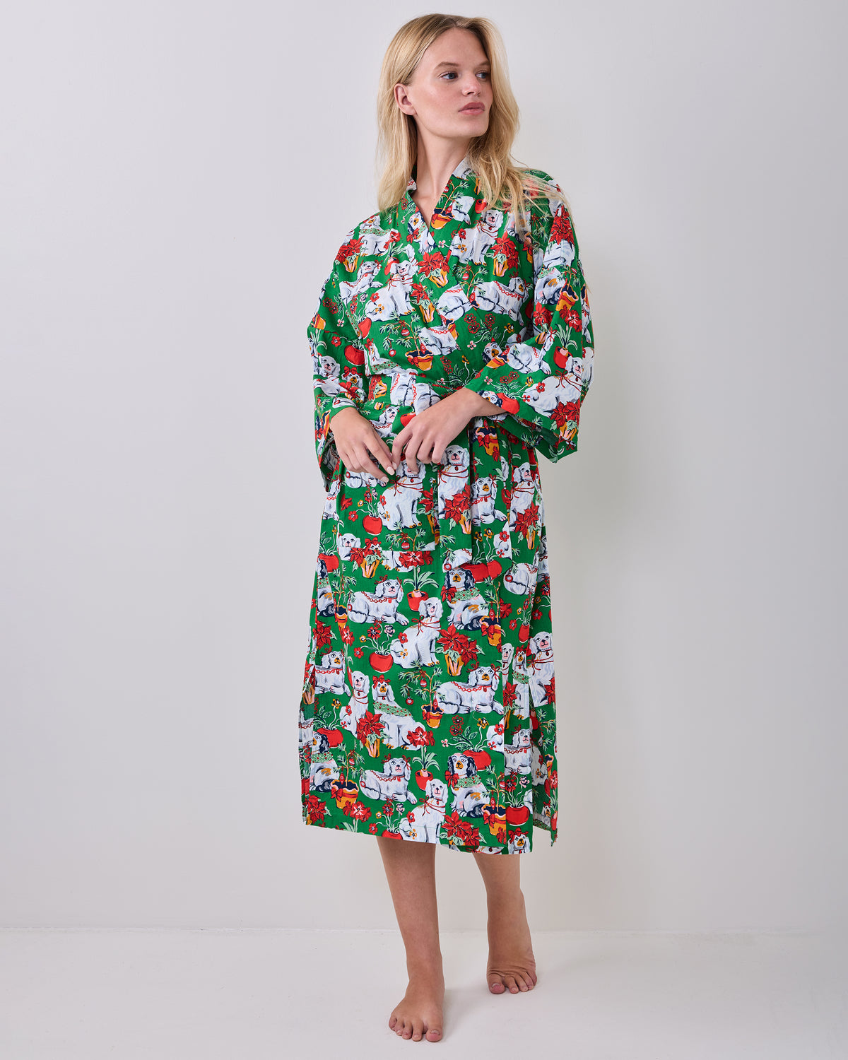 Full front view of a person wearing the green festive-print long robe with a matching belt.