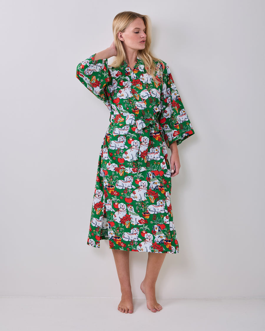 Front view of a person wearing a green printed long robe tied with a matching belt.