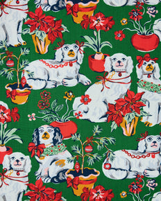 Evergreen Good Dog Christmas print with white dogs, poinsettias, potted plants, and holiday decorations