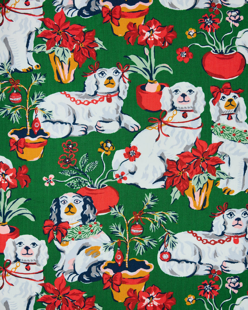 Evergreen Good Dog Christmas print with white dogs, poinsettias, potted plants, and holiday decorations
