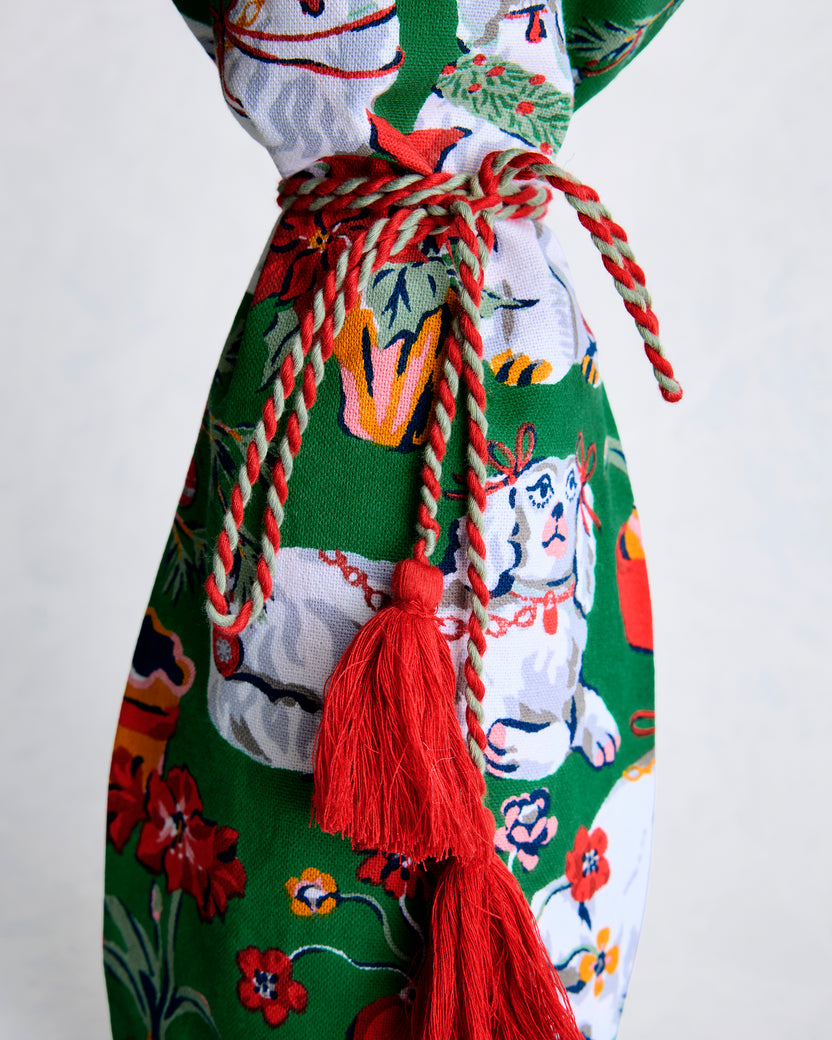 Close-up of the green dog-print wine bag's braided tie and red tassels.