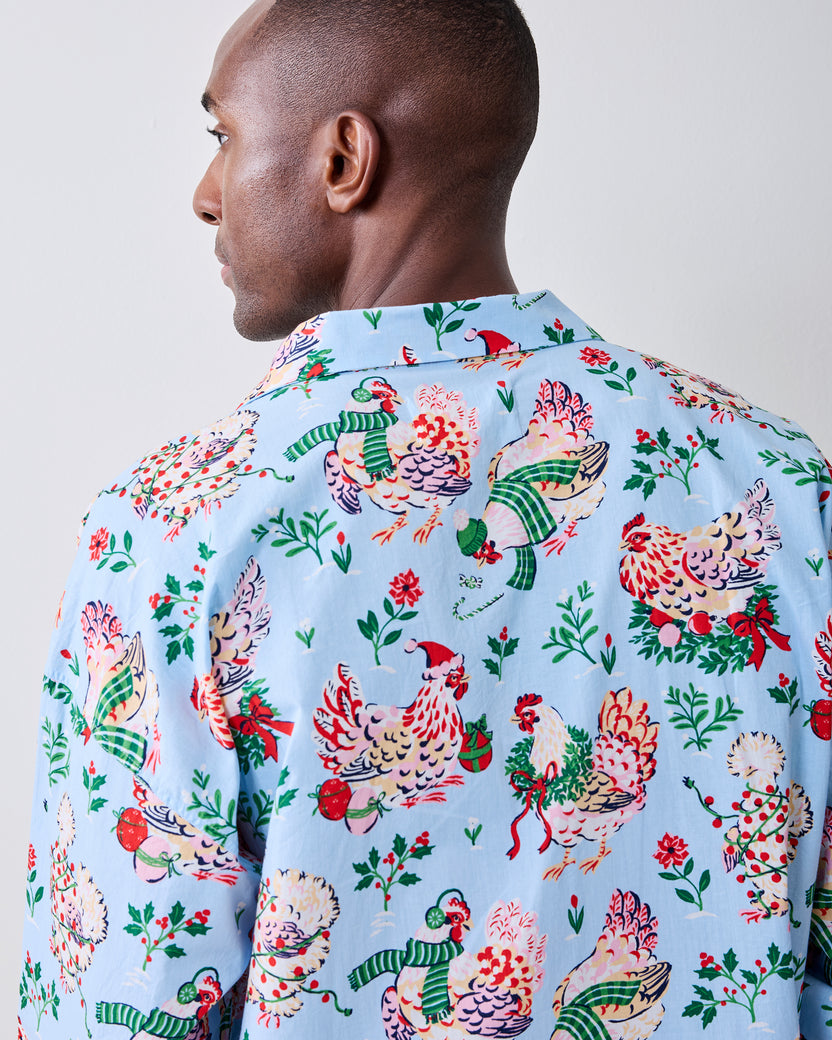 Back view of the pale blue holiday hen pajama shirt showing the all-over print and collar.