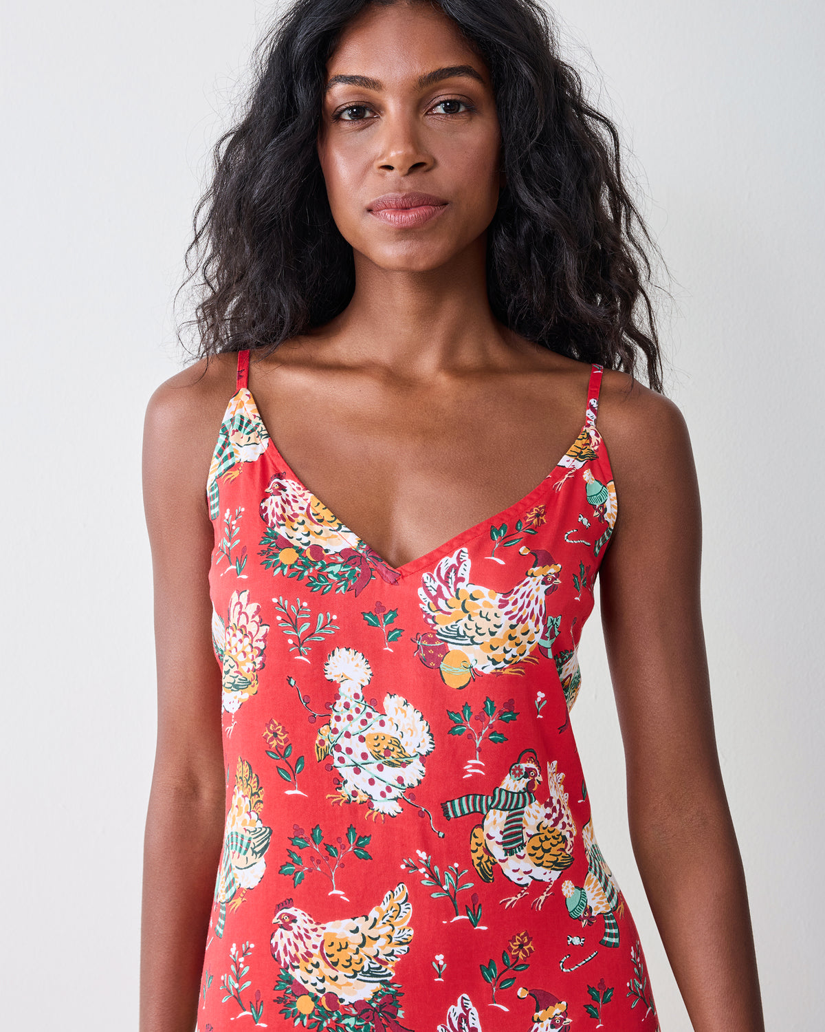 Close-up of the red Holiday Hens nightie showing its V-neckline, shoulder straps, and printed hen pattern.