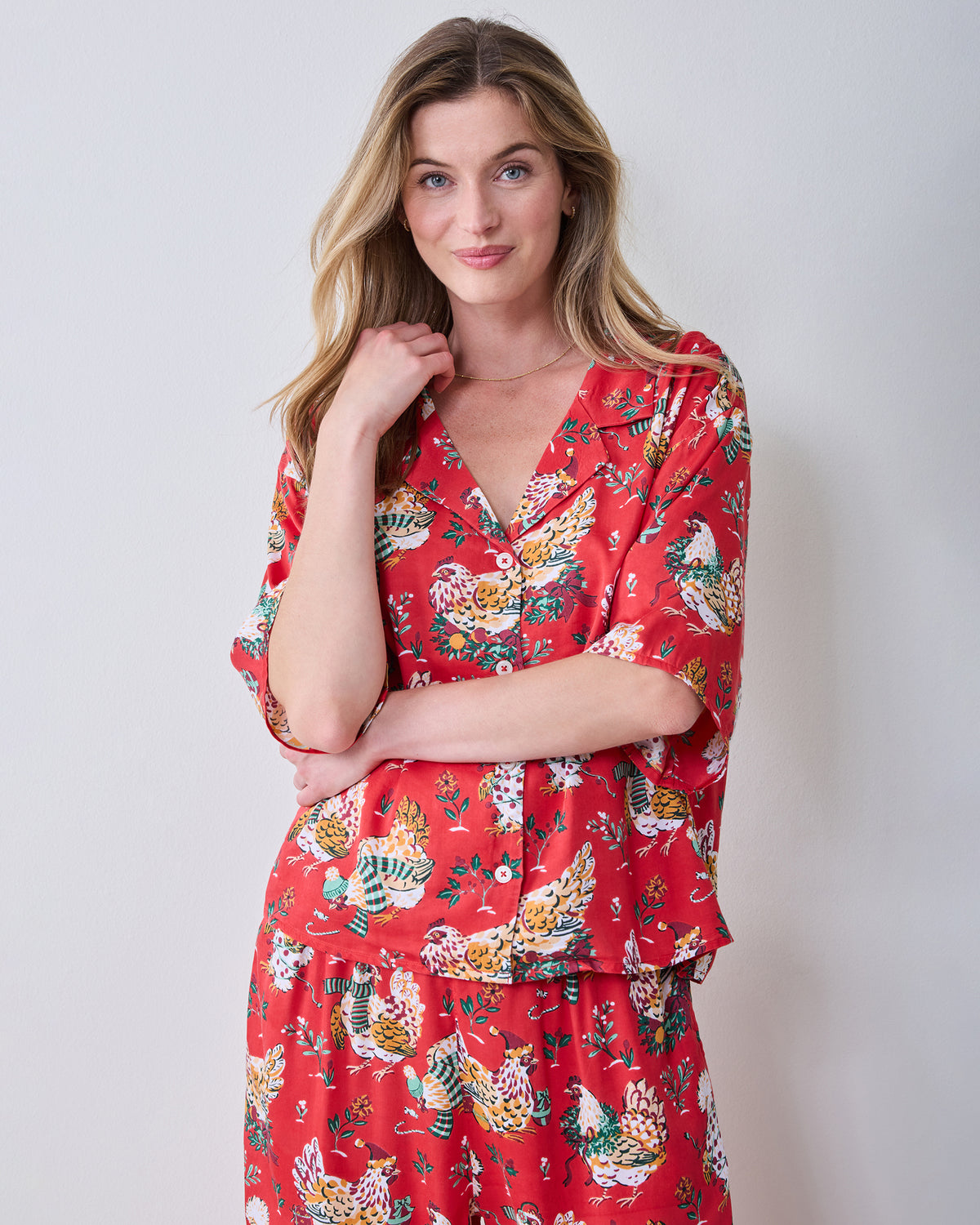 Red Holiday Hens pajama set with a short-sleeve button-front top and matching wide-leg pants, shown from the front