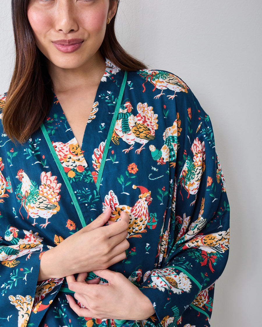 Close view of the Holiday Hens satin robe showing the V-neckline, contrasting green trim, and dark blue chicken print.