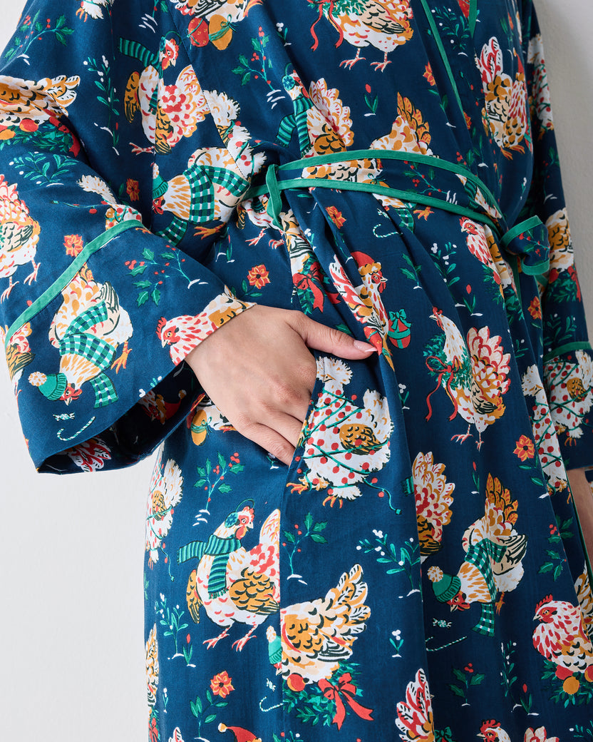 Close view of the Holiday Hens satin robe showing the tied belt, contrasting green trim, sleeve cuff, and side pocket.