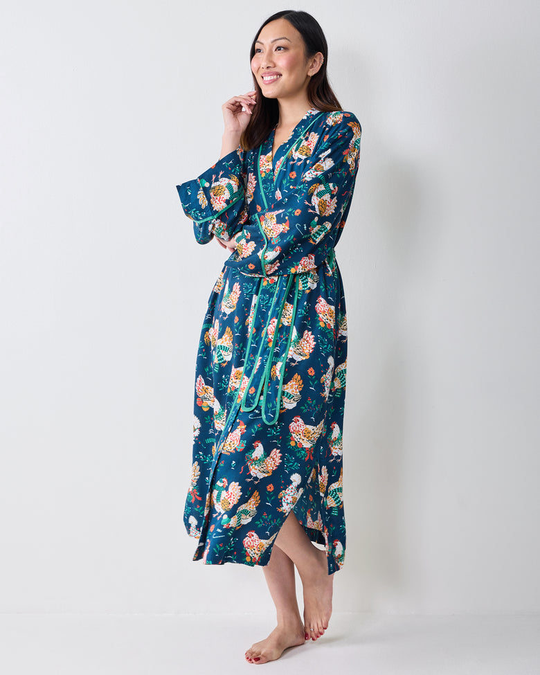 Three-quarter view of a model wearing the Holiday Hens wrap robe with a belted waist and side opening.