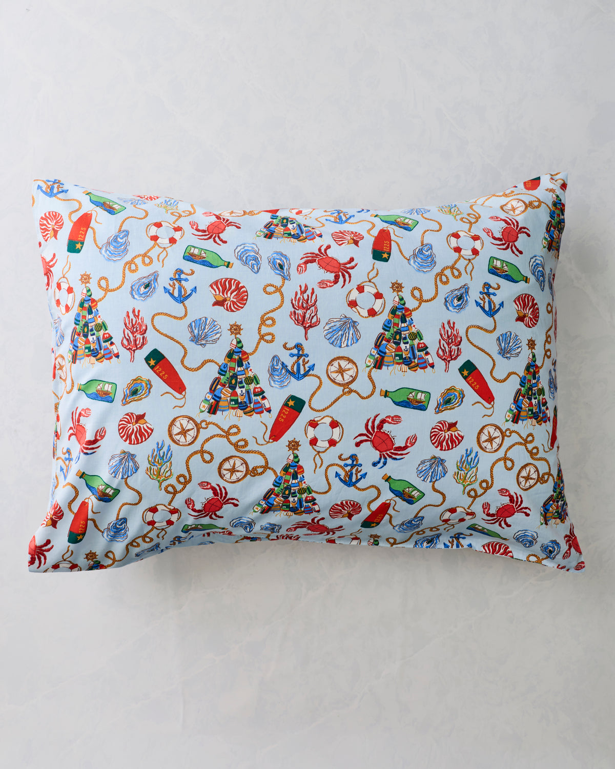 Two pale blue pillowcases with a repeating nautical holiday print, displayed flat against a light background.
