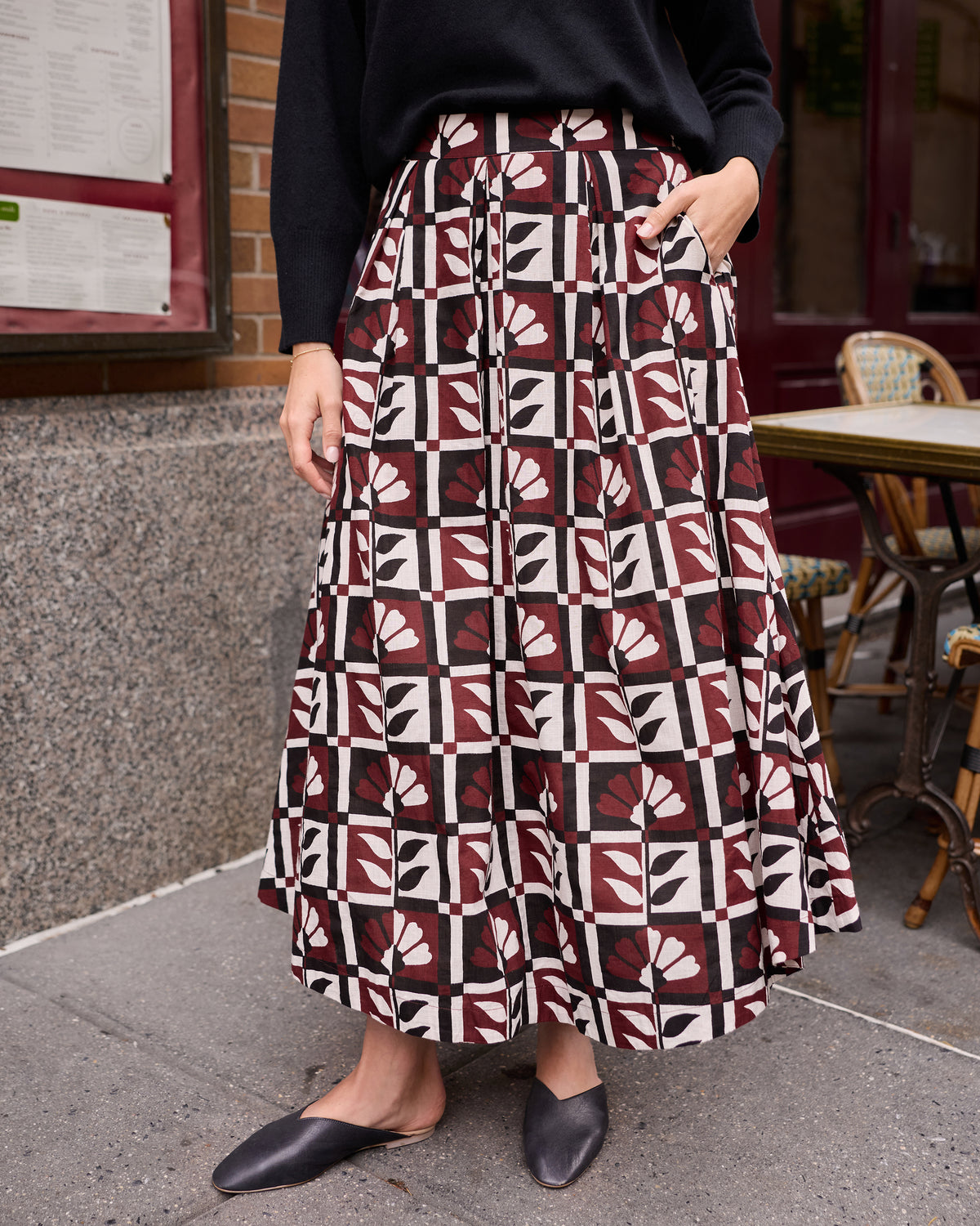Close view of the Bordeaux Sparrow Skirt with a burgundy, cream, black, and white geometric floral print and side pockets.