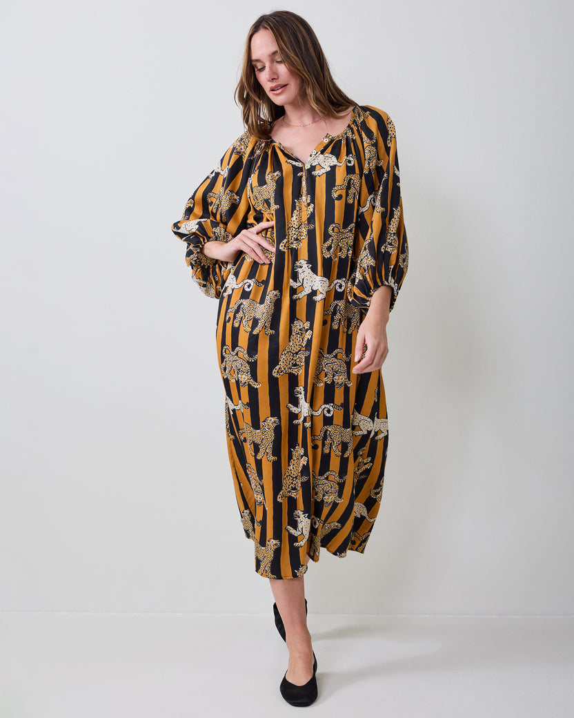 Three-quarter front view of the Leopard Stripes Felicity dress showing the V-neckline, gathered sleeves, waist tie, and midi-length skirt.