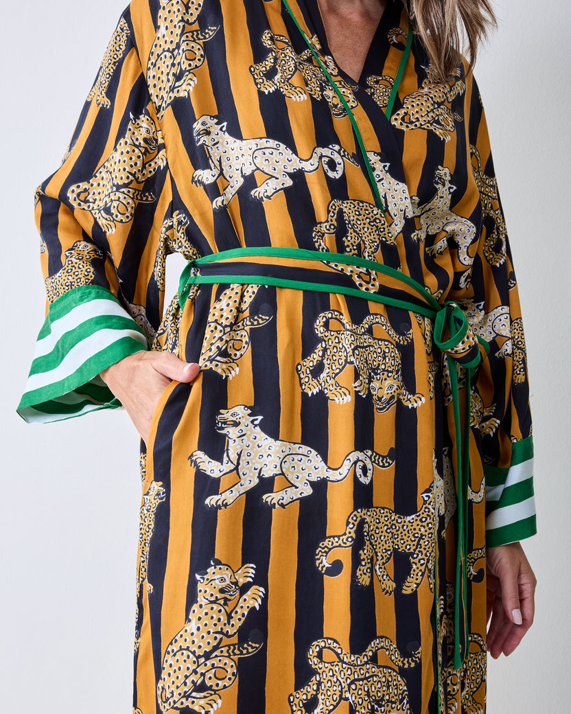 Close view of the butterscotch Leopard Stripes robe showing the leopard print, green waist tie, and side pocket.