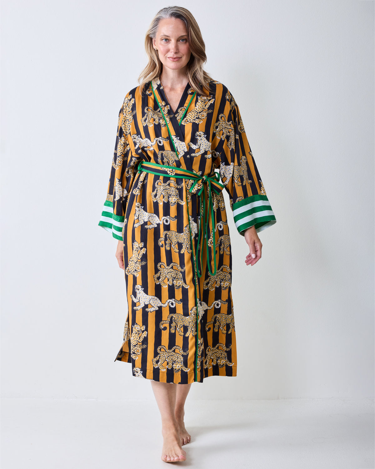 Front view of a butterscotch striped leopard-print robe with a green-and-white striped cuff trim and waist ties.