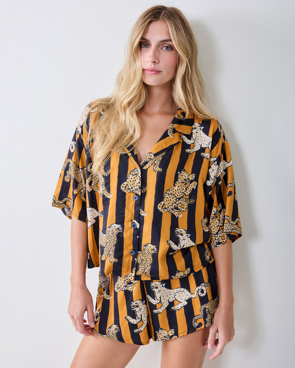 Front view of the butterscotch Leopard Stripes short-sleeve top and shorts set with a button-front shirt and leopard print.