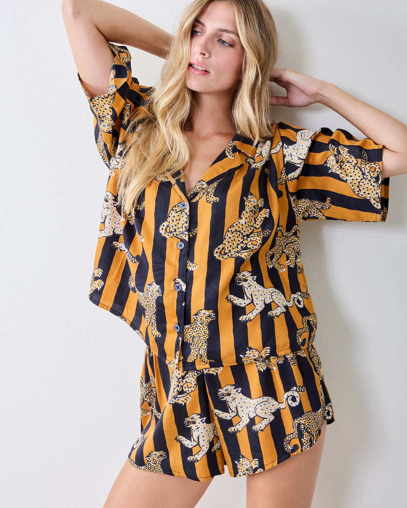 Front view of the striped leopard-print pajama set with a short-sleeve button-front top and shorts.