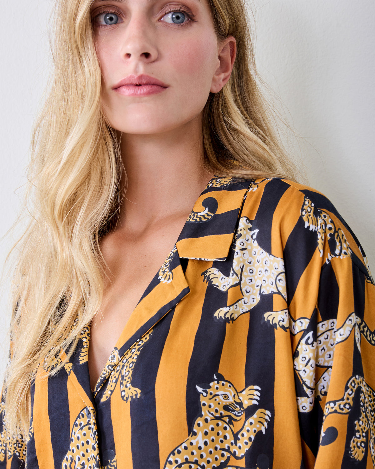 Close-up of the striped leopard-print short-sleeve pajama top with a notched collar and button front.