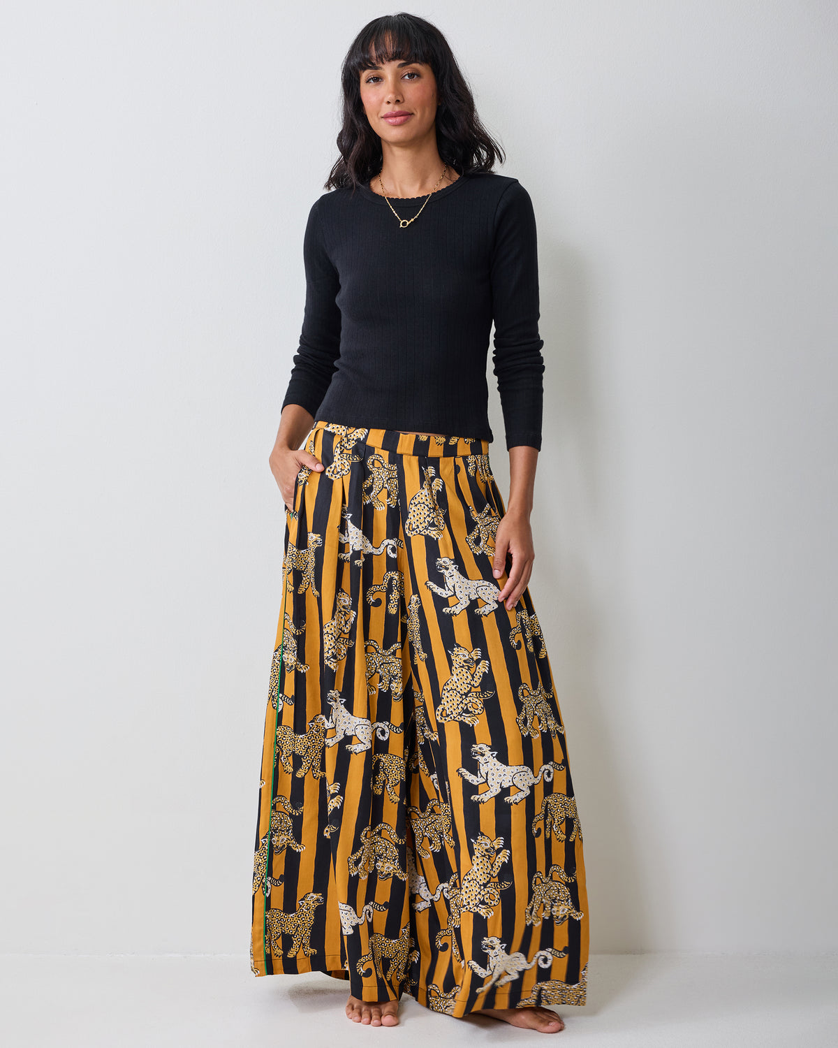 Full front view of the Leopard Stripes Tribeca pants, showing the wide-leg cut, pockets, and leopard print on butterscotch-and-black stripes.