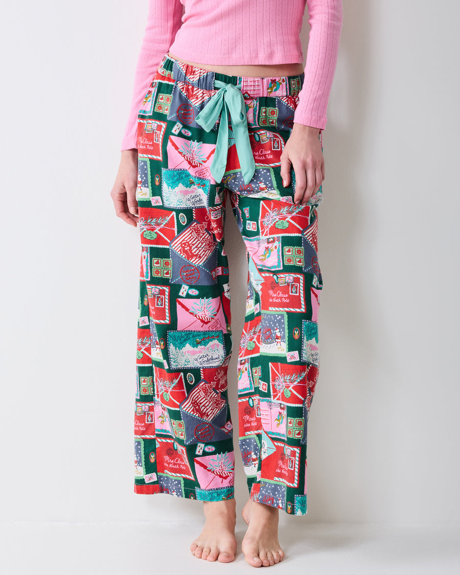 Close-up front view of the printed Astrid pants showing the drawstring waist, pockets, and straight-leg cut.