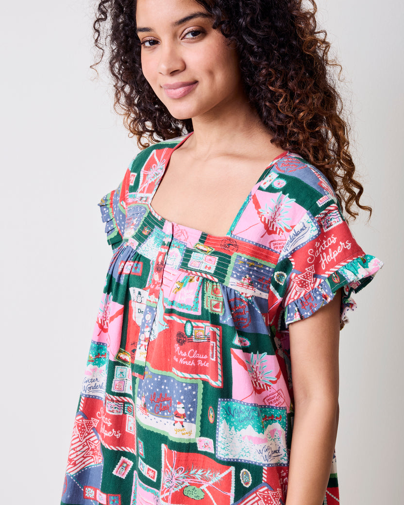 Close-up of a person wearing the printed nightgown, showing its square neckline and ruffled short sleeves.
