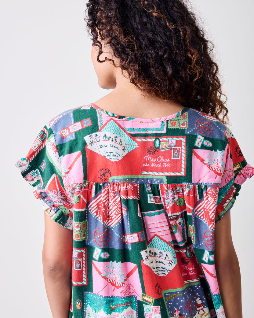 Back view of the Letters to Santa printed daylight nightgown, showing its gathered waist and short ruffled sleeves.