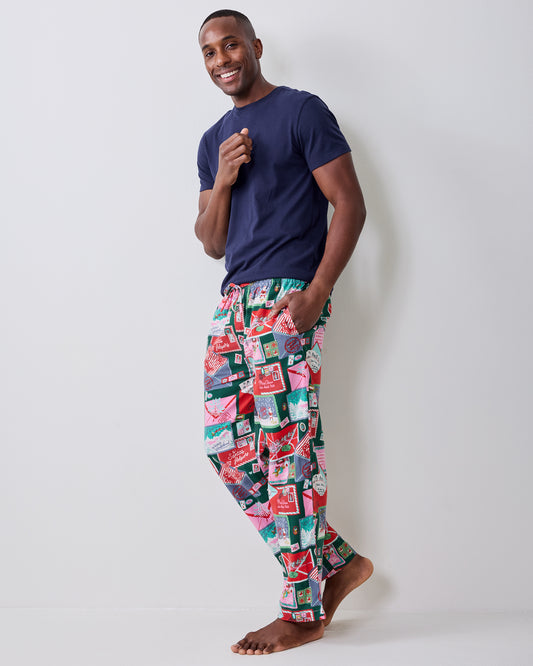 Side view of a person wearing the long printed pajama pants, showing the full-length legs and tapered hems.