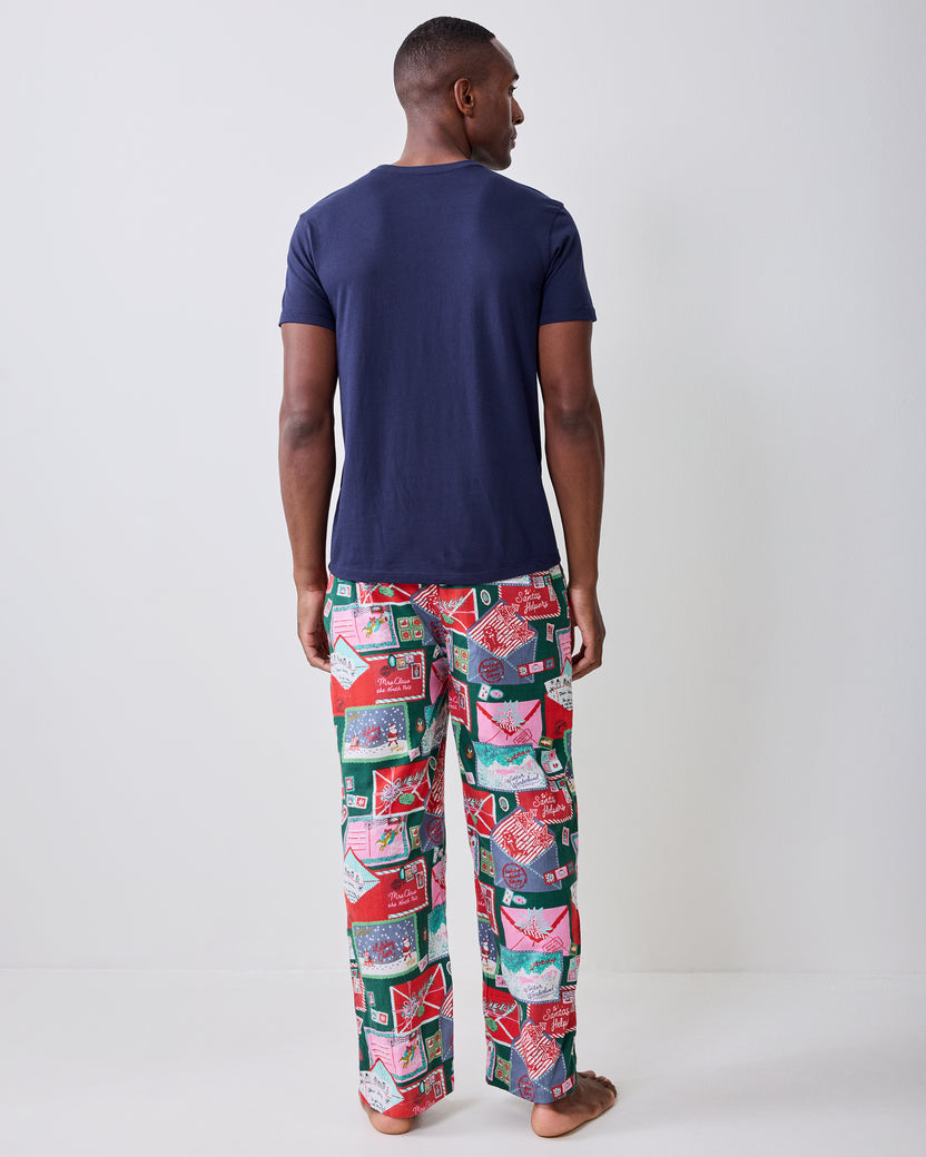Back view of a person wearing the long printed pajama pants, showing the rear waistband and full-length legs.