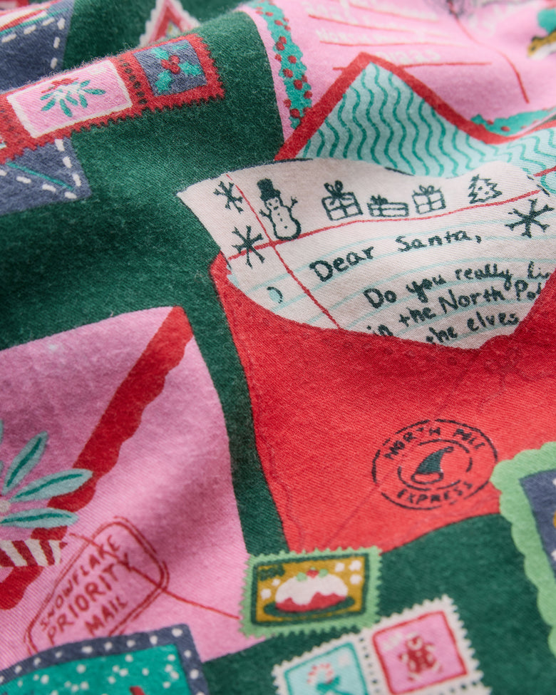 Close-up of the holiday print with a letter addressed to Santa, envelopes, stamps, and winter illustrations.