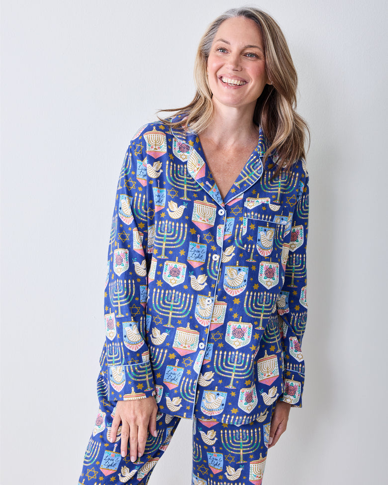 Full-length front view of a person wearing the blue Love & Light Hanukkah-print long pajama set.