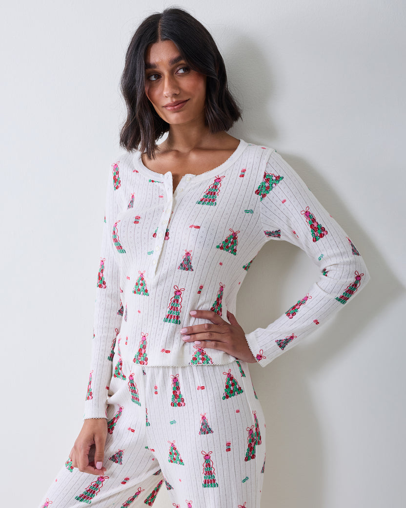 Front three-quarter view of the buttercream Kaylee Set top and matching pants with a colorful macaron tower print.
