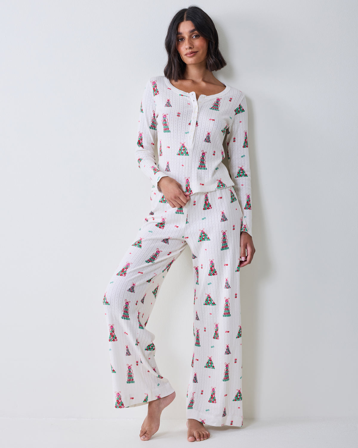 Full front view of the buttercream Kaylee Set with a long-sleeved top and wide-leg pants covered in a colorful macaron tower print.
