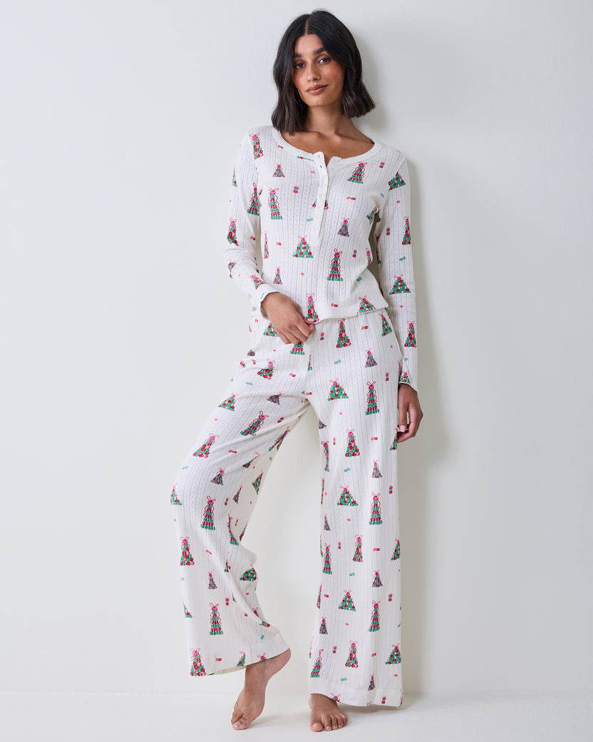 Full front view of the buttercream Kaylee Set with a long-sleeved top and wide-leg pants covered in a colorful macaron tower print.