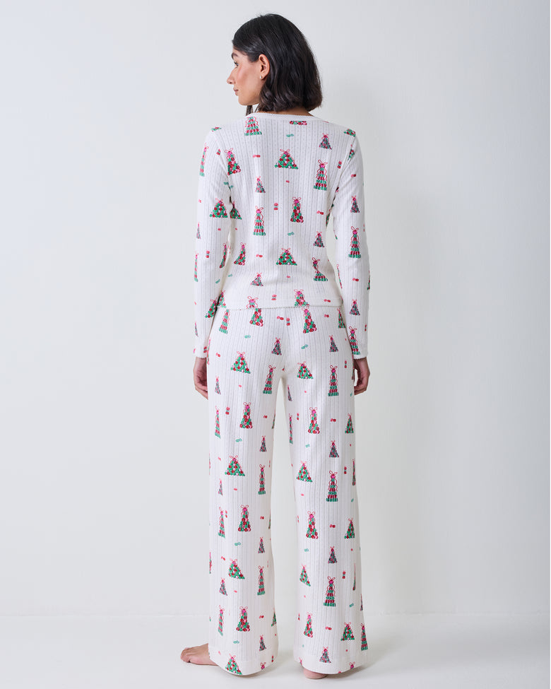 Back view of the buttercream Kaylee Set, showing the long-sleeved top and wide-leg pants with a colorful macaron tower print.