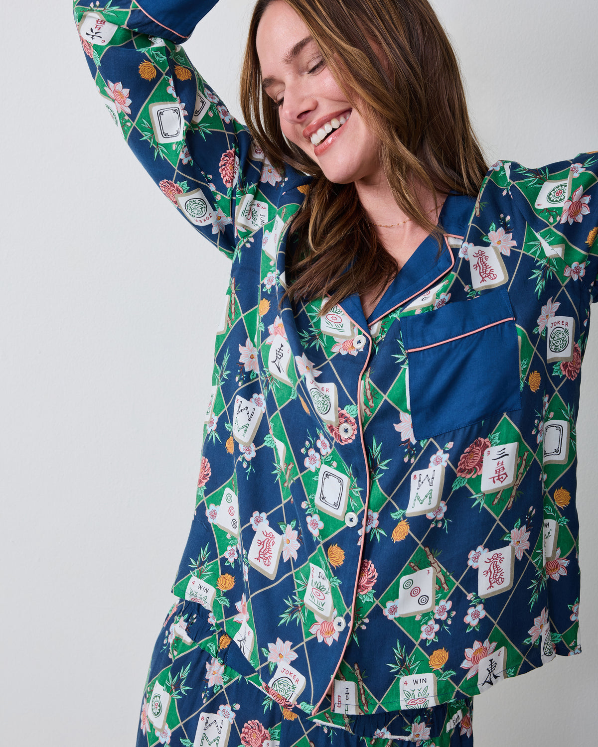 Close front view of the Mahj Garden Wintergreen Eco Satin Soho pajama set, showing the patterned button-front top, chest pocket, and matching pants waistband.