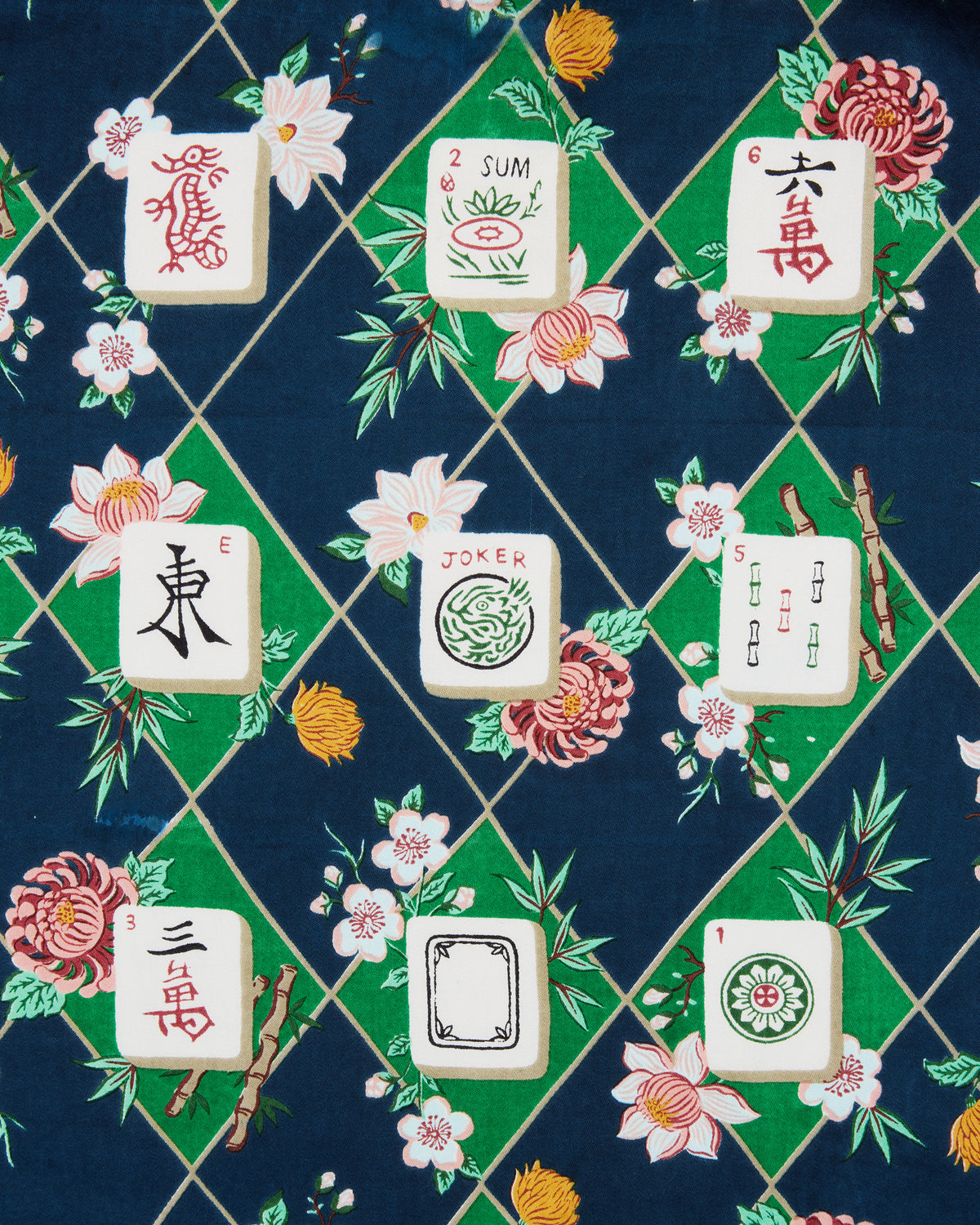 Close-up of the Mahj Garden Eco Satin Soho Set print, showing floral motifs, green diamonds, and illustrated mahjong tiles on a dark blue background.