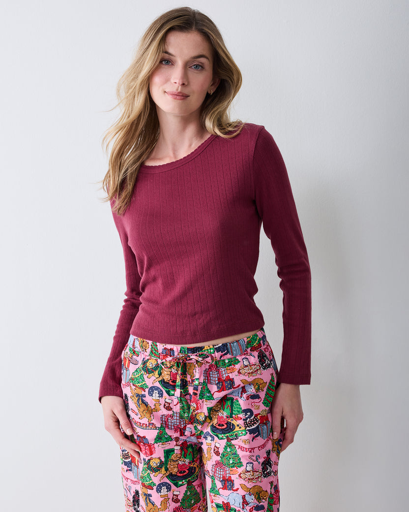 Front detail of the Candy Pink Meowy Christmas cropped pajama pants, showing the drawstring waist, side pockets, and printed design.