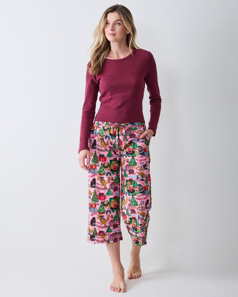 Front view of the Candy Pink Meowy Christmas cropped pajama pants, worn with a burgundy long-sleeve top.
