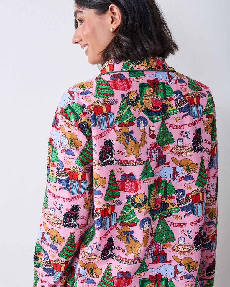 Close back view of the candy pink pajama top, showing the collar, back panel, sleeves, and Christmas cat-and-gifts print.